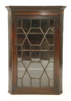 Lot 1051 - A mahogany hanging corner cabinet