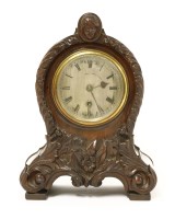 Lot 877 - A carved mahogany case mantel clock
