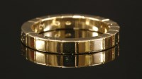 Lot 389 - An 18ct gold Cartier Lanieres flat section band ring