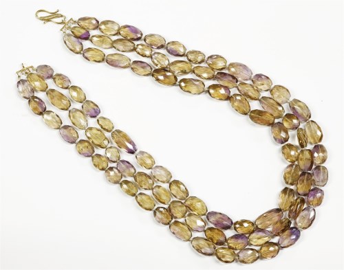 Lot 33 - A three row graduated oval faceted ametrine bead necklace