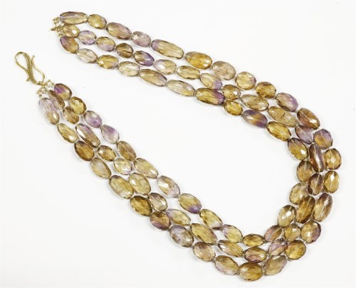 Lot 37 - A three row graduated oval faceted ametrine bead necklace