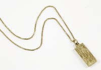 Lot 5 - A 9ct gold ingot pendant suspended on a gold box link chain
