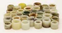 Lot 63 - A large quantity of approximately 35 jade and other hardstone archer's rings