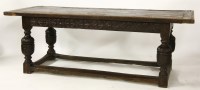 Lot 731 - A 17th century style oak refectory table with a plank top on carved cup and cover supports
