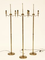 Lot 596 - Three contemporary brass twin branch floor standing standard lamps