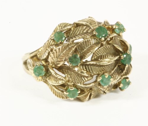 Lot 10 - A 9ct gold emerald set leaf design bombé shaped ring 
7.29g