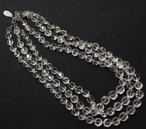Lot 16 - A three row graduated faceted bouton shaped rock crystal bead necklace