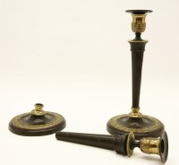 Lot 205 - A pair of Regency style bronzed and gilt highlighted candlesticks