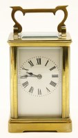 Lot 156 - An early 20th century brass and fire glass carriage clock