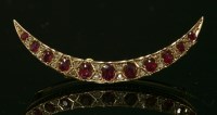 Lot 100 - An Edwardian ruby and diamond crescent brooch