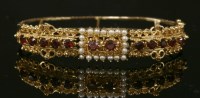 Lot 328 - An American Victorian-style garnet and cultured pearl hinged bangle