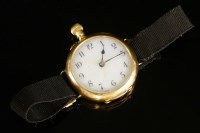 Lot 605 - A ladies' 18ct gold early mechanical strap watch