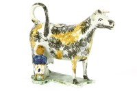 Lot 213 - A Staffordshire or Yorkshire pearlware cow creamer with milkmaid