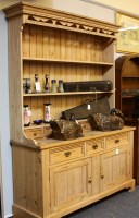 Lot 624 - A reproduction stripped pine kitchen dresser