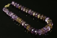 Lot 734 - A single row graduated faceted bouton shaped ametrine bead necklace