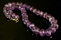 Lot 735 - A single row graduated faceted bouton shaped amethyst bead necklace