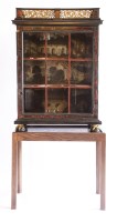Lot 927 - A Continental ebony and red tortoiseshell glazed display cabinet
