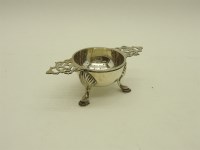 Lot 134 - A silver tea strainer and stand