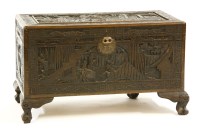Lot 570 - A Chinese carved camphorwood trunk