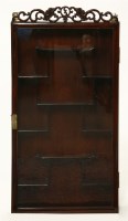 Lot 522 - An oriental hardwood glazed wall hanging display cabinet