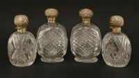 Lot 204 - Two pairs of Victorian cut glass cologne bottles with silver covers