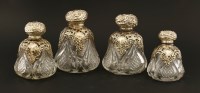 Lot 208 - A set of four cut and moulded glass cologne bottles