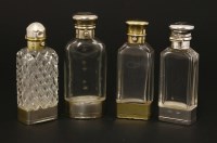 Lot 64 - Four silver and glass combination scent bottles and vinaigrettes