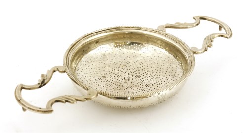 Lot 155 - A George III silver two-handled lemon strainer