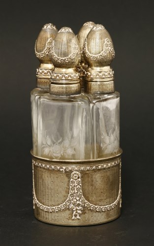 Lot 189 - A late 19th/20th century French silver gilt four-bottle perfume set
