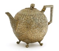 Lot 242 - An Indian silver repoussé teapot