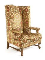 Lot 556 - A 1920's upholstered wing armchair