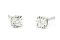 Lot 12 - A pair of white gold single stone diamond illusion set earrings