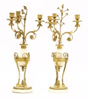 Lot 1192 - A pair of George III ormolu and white marble three-light candelabra