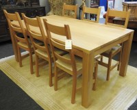 Lot 609 - A solid light oak rectangular table with six matching solid light oak ladder back chairs
