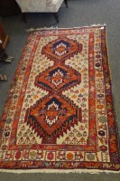 Lot 592A - A triple banded red and cream border rug