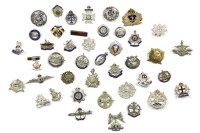 Lot 100A - A collection of military cap badges and brooches