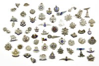 Lot 104A - A collection of military cap badges and brooches
