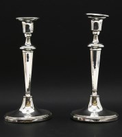 Lot 128 - A pair of silver candlesticks