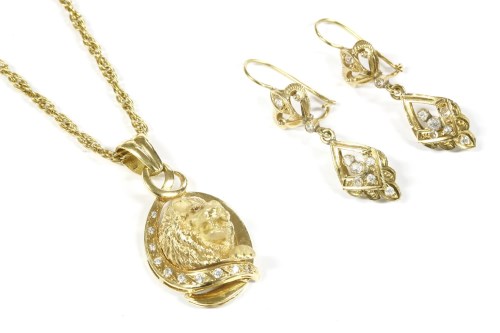 Lot 29 - A gold lion head pendant set with cubic zirconias