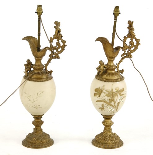 Lot 291 - A pair of large Victorian gilt metal and opaline glass table lamps