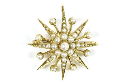Lot 20 - A late Victorian gold split pearl star brooch/pendant