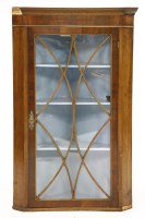 Lot 320 - A 19th century mahogany hanging corner cabinet
