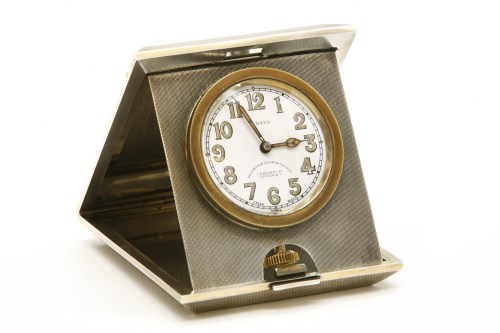 Lot 112 - A silver and engine turned 'Pop Up' travel clock