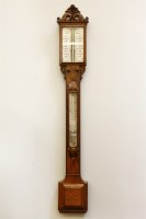 Lot 264 - A walnut stick barometer