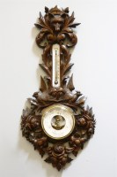 Lot 274 - A Black Forest style carved aneroid barometer