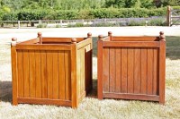 Lot 537 - A pair of teak planters