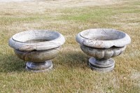 Lot 536 - A pair of serpentine like reconstituted stone urns with reeded bodies