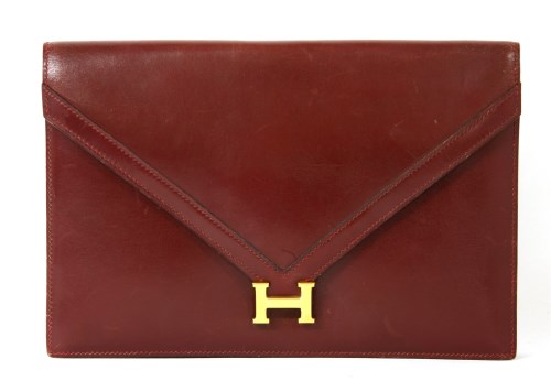 Lot 1126 - An Hermès 'Liddy' oxblood red clutch handbag