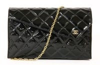 Lot 1004 - A vintage Chanel black patent quilted clutch handbag