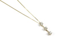 Lot 21 - A gold three stone diamond bar pendant